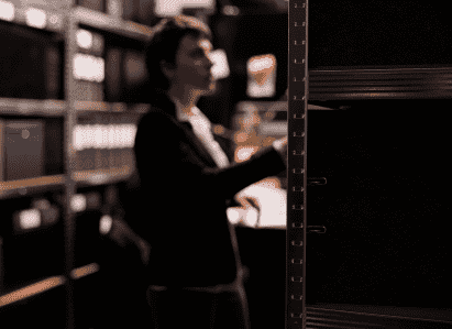 employee accessing storage room with metal shelving