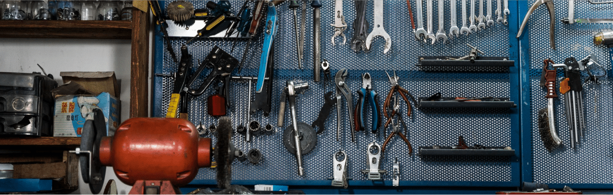 Various tools displayed on a blue metal shelf