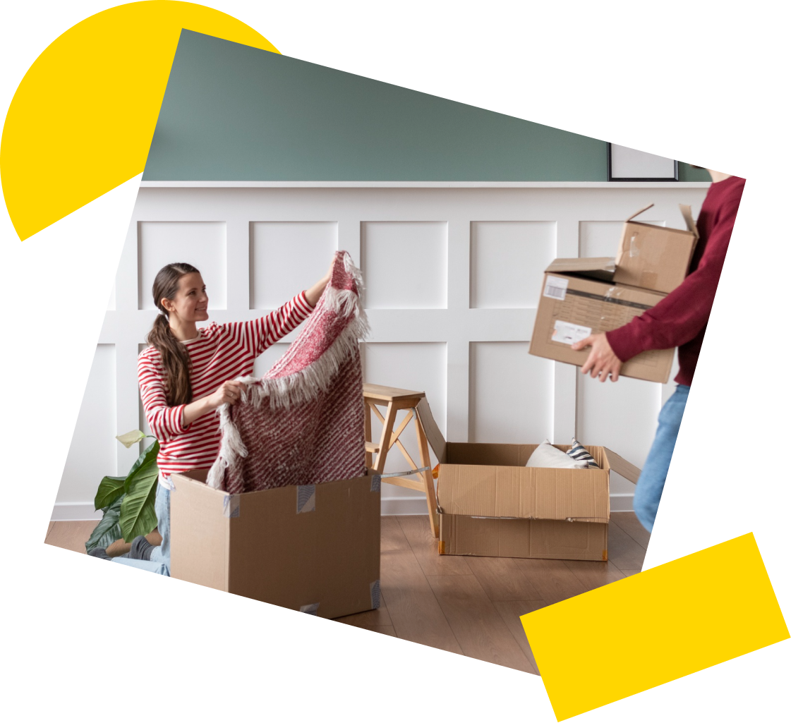 Couple unloading their belongings from cardboard boxes