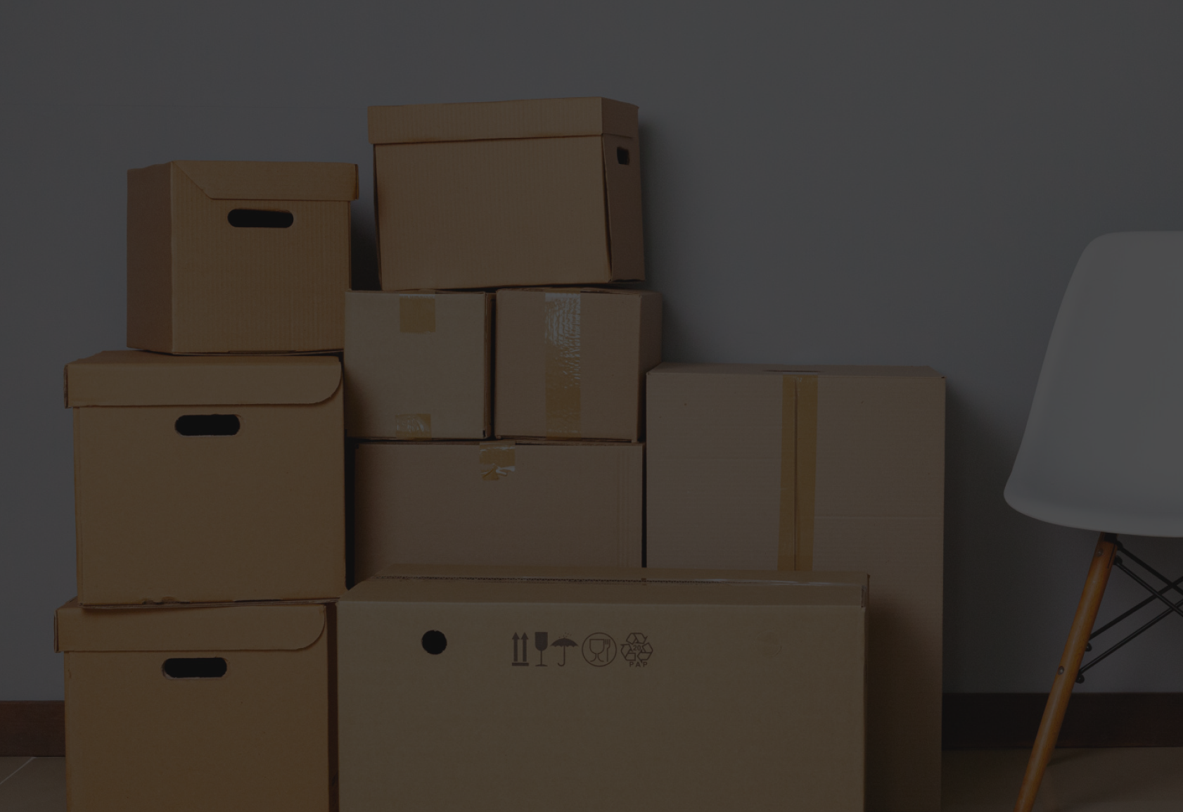 Stack of cardboard boxes in an empty room