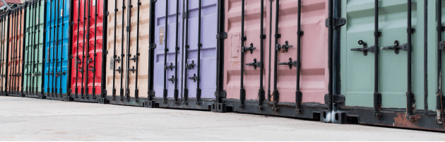 A row of different coloured metal containers outside